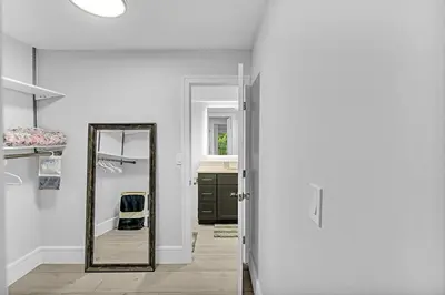 a hallway with a mirror and a sink at One Bedroom Steps Away From The Beach! in Sunny Isles Beach