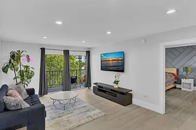 a living room with a couch and a table at One Bedroom Steps Away From The Beach! in Sunny Isles Beach
