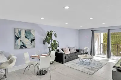 a living room with a couch and a table at One Bedroom Steps Away From The Beach! in Sunny Isles Beach