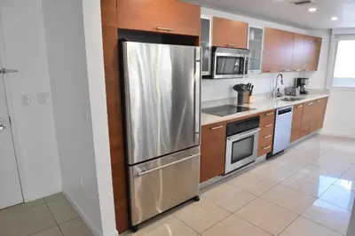 a kitchen with a stainless steel refrigerator at 515-Trendy 2Bd2Ba Midtown HUGE private patio! in Miami