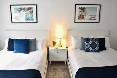 two beds sitting next to each other in a bedroom at 515-Trendy 2Bd2Ba Midtown HUGE private patio! in Miami
