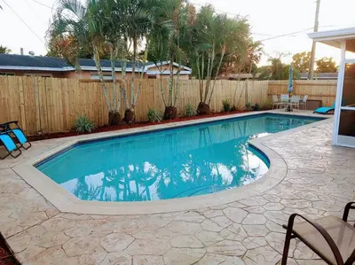 a swimming pool in a backyard with a fence at Amazing 5 Bedroom Pool Home - Minimum 28 days Stay Only Great Location! in Miramar