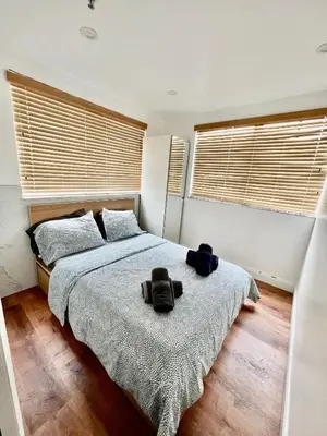 a bedroom with a bed with two bags on it at Seaside Serenity Duplex in Miami Beach