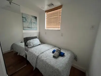a bedroom with two twin beds and a mirror at Seaside Serenity Duplex in Miami Beach
