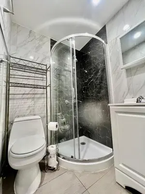 a bathroom with a toilet and a shower at Seaside Serenity Duplex in Miami Beach
