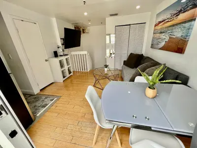 a living room with a table and a couch at Seaside Serenity Duplex in Miami Beach