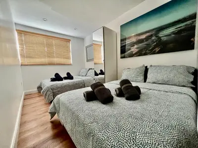 a bedroom with two beds with brown pillows on them at Seaside Serenity Duplex in Miami Beach