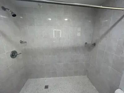 a bathroom with a shower with a tiled shower at Fully equipped Apartments with parking near Cocowalk in Miami