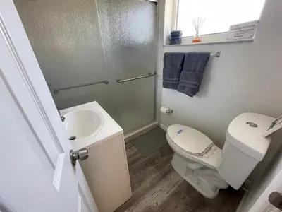 a bathroom with a toilet and a sink and a shower at Fully equipped Apartments with parking near Cocowalk in Miami