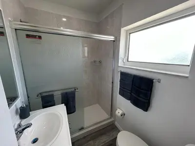a bathroom with a shower and a sink and a toilet at Fully equipped Apartments with parking near Cocowalk in Miami
