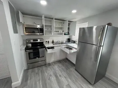 a kitchen with a stainless steel refrigerator and appliances at Fully equipped Apartments with parking near Cocowalk in Miami