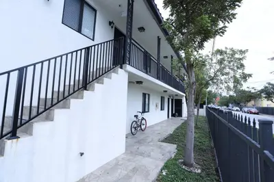 a bike parked next to a white building with a staircase at Apartments Little Habana near calle 8 in Miami