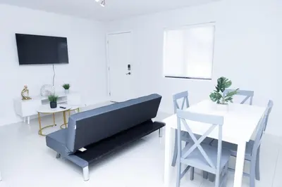 a living room with a bench and a table and a tv at Apartments Little Habana near calle 8 in Miami
