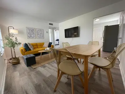 a dining room and living room with a table and chairs at Remodeled Little Havanna Apartments great location in Miami