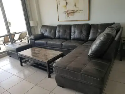 a leather couch and a coffee table in a living room at Beautiful Pavilion in Miami Beach