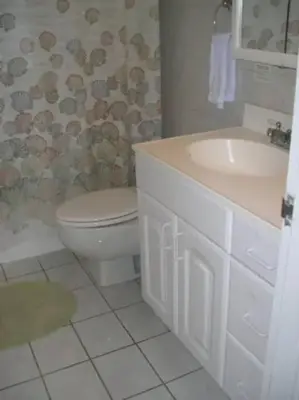 a bathroom with a toilet and a sink at Beautiful Pavilion in Miami Beach