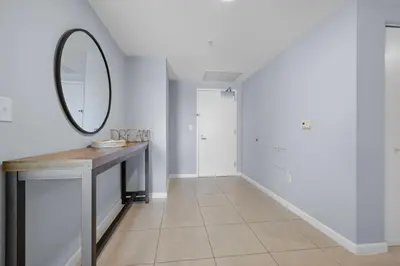 a hallway with a vanity and a mirror on a wall at 516-2Bd2Ba Midblock Apartment FREE parking in Miami