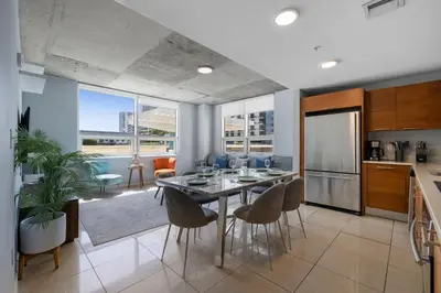 a kitchen and dining room with a table and chairs at 516-2Bd2Ba Midblock Apartment FREE parking in Miami
