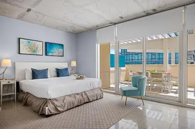 a bedroom with a bed and a table and a chair at 516-2Bd2Ba Midblock Apartment FREE parking in Miami