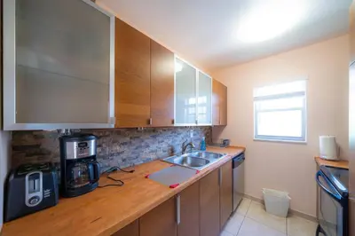 a kitchen with a sink and a coffee maker at Enjoy Fully Equipped 2BR Condo Near The Beach in Sunny Isles Beach