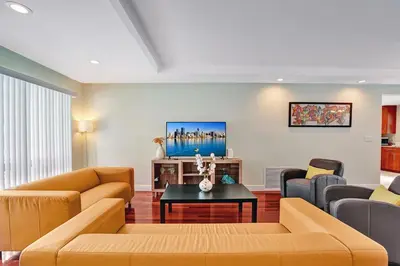 a living room with a couch and a table at Best Area Spacious 4BR Heated Pool Mins To Beach in Hollywood