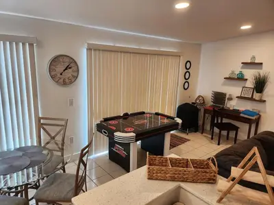 a living room with a pool table and a dining room at Walk to Hard Rock ~ Amazing 5 Star Home Away From Home! in Miami Gardens