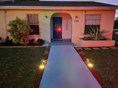 a house with a long white walkway in front of it at Walk to Hard Rock ~ Amazing 5 Star Home Away From Home! in Miami Gardens