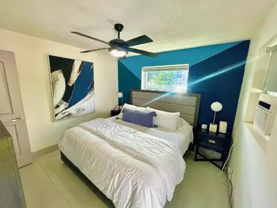 a bedroom with a bed with a ceiling fan at MiamiVice Las Olas Near Beach and Park w Fire Pit in Fort Lauderdale