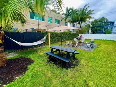 a hammock and a picnic table in a yard at MiamiVice Las Olas Near Beach and Park w Fire Pit in Fort Lauderdale