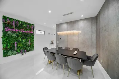 a dining room with a black table and chairs at Elements Las Olas w Pool and Spa Near Beach in Fort Lauderdale