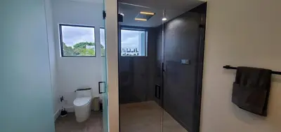 a bathroom with a shower and a toilet at Elements Las Olas w Pool and Spa Near Beach in Fort Lauderdale