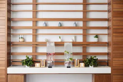 a wall of wooden shelves with potted plants at EVEN Hotel Miami - Doral Area by IHG in Sweetwater