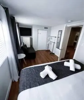 a bedroom with a bed with two white crosses on it at Charming 4BR Home with Heated Pool in Hollywood in Hollywood