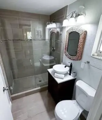 a bathroom with a shower and a toilet and a sink at Charming 4BR Home with Heated Pool in Hollywood in Hollywood