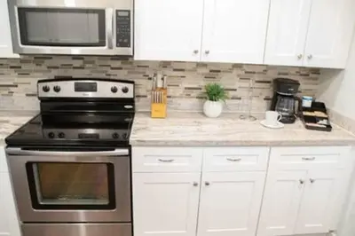 a kitchen with a stove and a microwave at Charming 4BR Home with Heated Pool in Hollywood in Hollywood