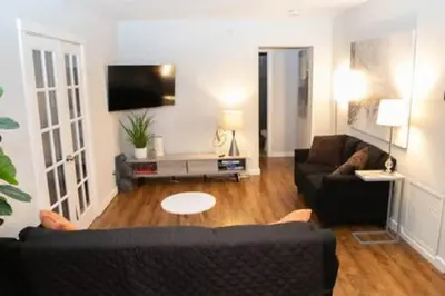 a living room with a couch and a tv at Charming 4BR Home with Heated Pool in Hollywood in Hollywood