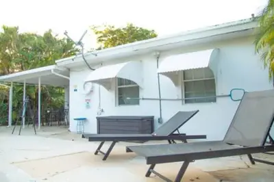 a house with a picnic table and a building at Charming 4BR Home with Heated Pool in Hollywood in Hollywood
