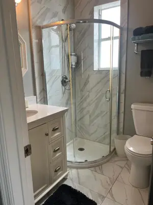 a bathroom with a shower and a toilet and a sink at Ocean Breeze Studio With Parking By The Beach in Miami Beach