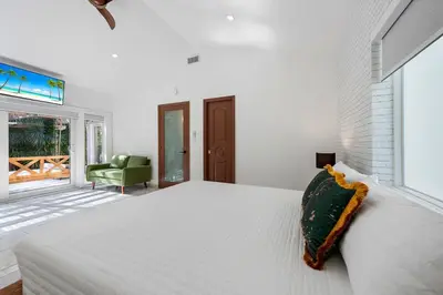 a white bedroom with a large bed and a window at The Wellness Retreat- Amazing Amenities Near Beach in Hollywood