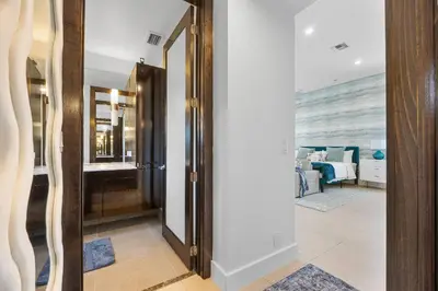 a hallway with a door leading to a bedroom at Sea La Vie FL in Fort Lauderdale