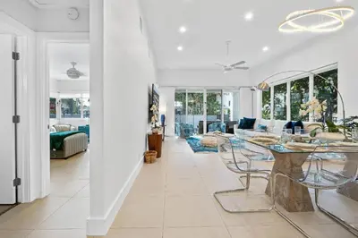 a dining room and living room with a table and chairs at Sea La Vie FL in Fort Lauderdale