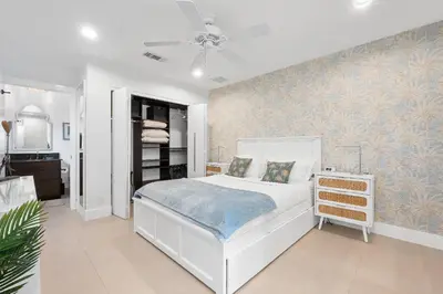 a bedroom with a white bed and a ceiling fan at Sea La Vie FL in Fort Lauderdale