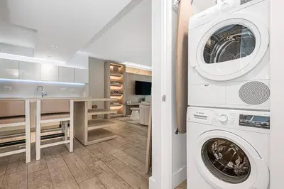 a white laundry room with a washer and dryer at 1 Hotel King Suite 1BR 1 5BA in Miami Beach
