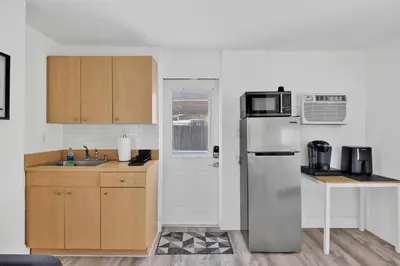 a kitchen with a refrigerator and a sink at Sunny Miami Stay - Pool - BBQ - Centrally Located in Miami