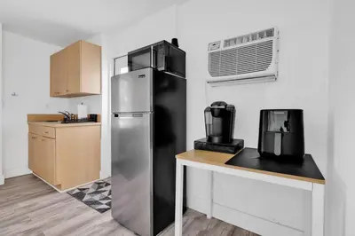 a kitchen with a stainless steel refrigerator and a counter at Sunny Miami Stay - Pool - BBQ - Centrally Located in Miami