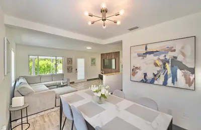 a living room with a table and a couch at Sunny Miami Stay - Pool - BBQ - Centrally Located in Miami