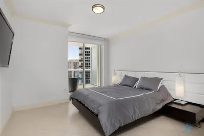 a bedroom with a large bed and a large window at Amazing View Beachfront Resort Luxury Amenities in Hallandale Beach