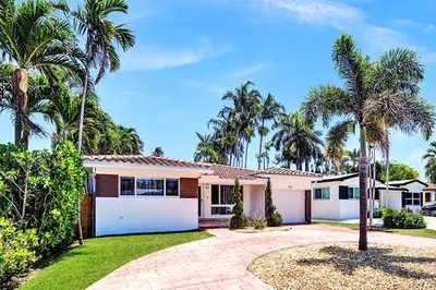 a house with palm trees in front of it at Seaside Oasis in Hollywood Lakes near the Beach in Hollywood