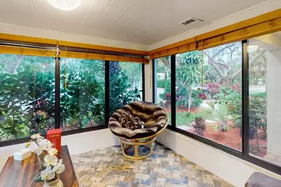 a room with a chair in front of a window at Walking On Sunshine in Fort Lauderdale