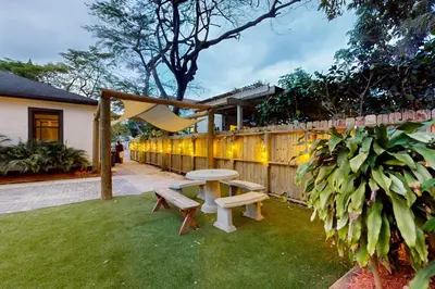 a backyard with a picnic table and a fence at Walking On Sunshine in Fort Lauderdale